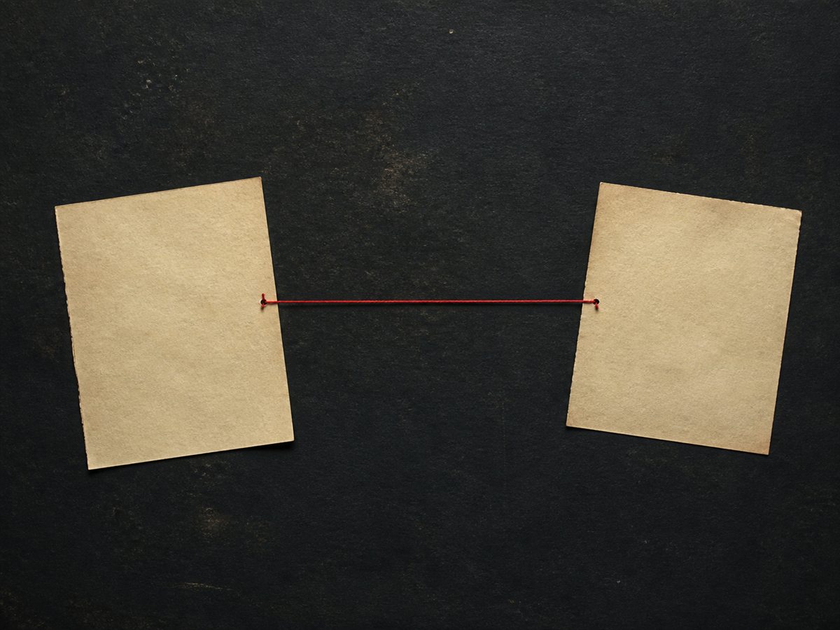 Two archival papers joined by a single red thread